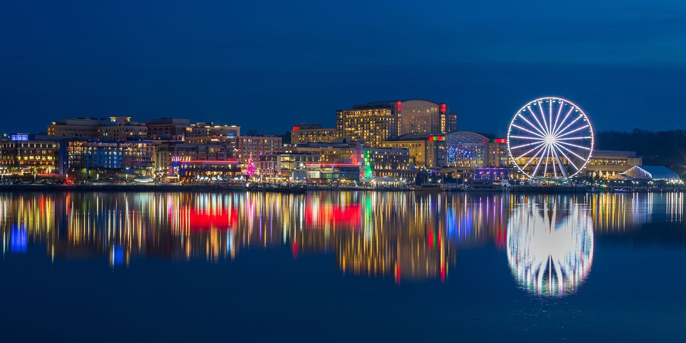 Scenic waterfront view of National Harbor, MD, the home of Katsucon—where anime fans gather for an unforgettable convention experience. Featuring the Ferris wheel, waterfront, and vibrant atmosphere perfect for cosplay and anime merch shopping.